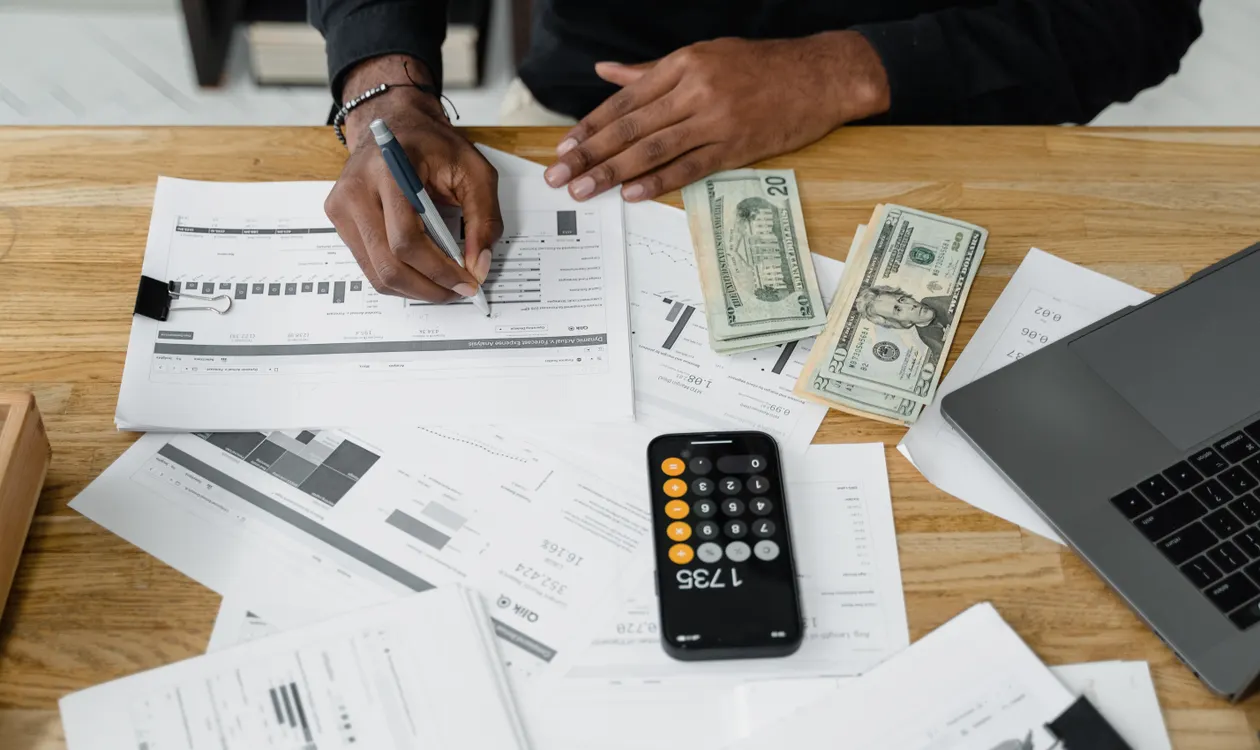 Accountant working at a desk with calculator and financial paperwork