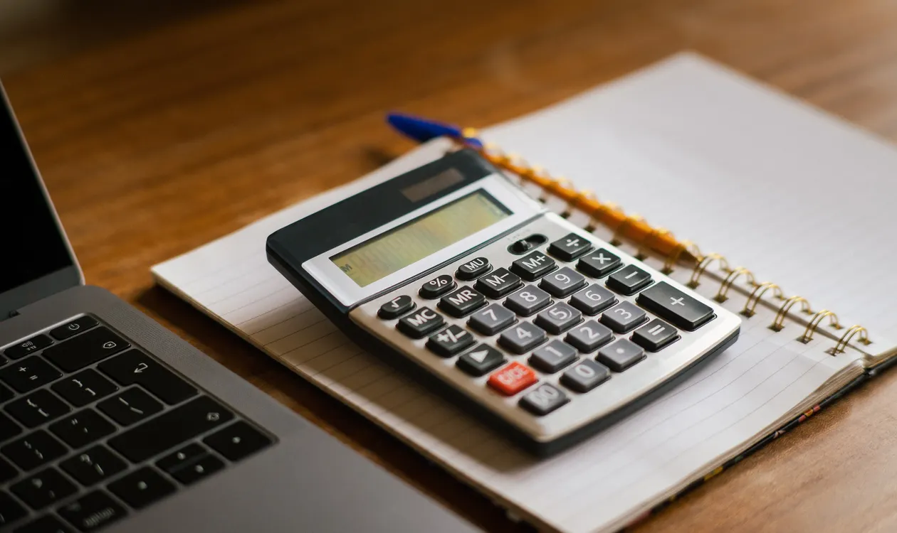 Calculator and laptop used to work out P11D benefit in kind values